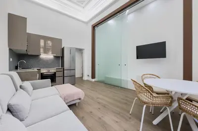a living room with a couch and a table at Apartamento Rambla Cataluña 35 in Barcelona