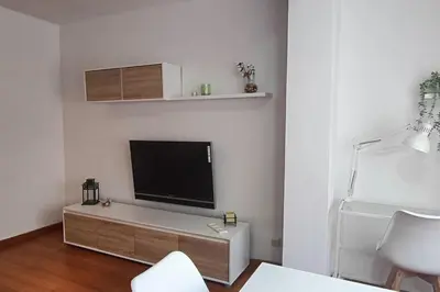a living room with a flat screen tv on a wall at Apartamento Gran Via para 6 en el centro de Premià in Premiá de Mar