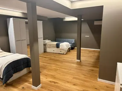 a bedroom with two beds and wooden floors at chalet barcelona in Barcelona