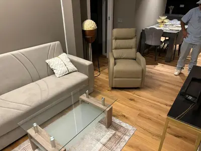 a living room with a couch and a chair and a table at chalet barcelona in Barcelona