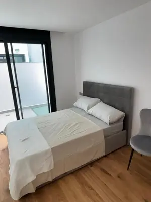 a bedroom with a large bed and a chair at chalet barcelona in Barcelona