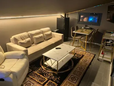 a living room with a white couch and a tv at chalet barcelona in Barcelona