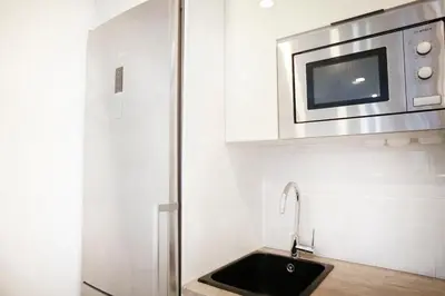 a kitchen with a sink and a microwave at Apartment-4people-Parking-Castelledefels-Bikes-Bbq in Castelldefels