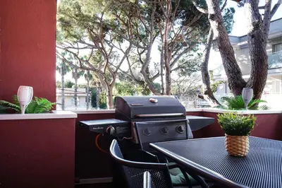 a grill sitting on a table in front of a window at Apartment-4people-Parking-Castelledefels-Bikes-Bbq in Castelldefels