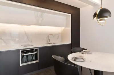 a kitchen with a sink and a table with chairs at The Passage Homes - Simaba Group in Barcelona