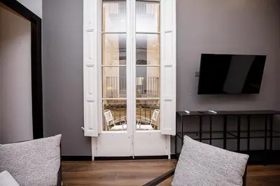 a room with a white cabinet with a window at beautiful cosy modern apartment ,19th century building in Barcelona