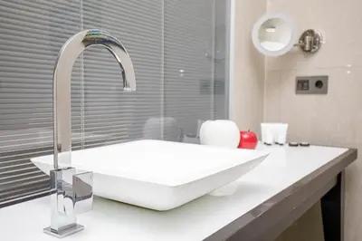 a bathroom with a white sink and a mirror at beautiful trendy spacious apartment very central location in Barcelona