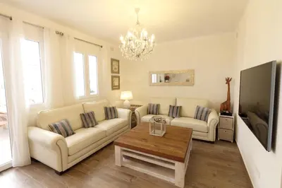 a living room with two couches and a coffee table at Sitges Centre Mediterranean House- 5 Bedroom, 4 Bathroom, Terrace Courtyard, Private Rooptop Pool in Sitges