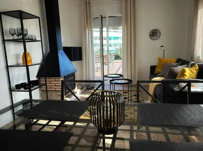 a living room with a couch and a table at Ático gran terraza cerca BCN in Castelldefels
