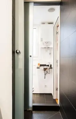 a hallway leading to a bathroom with a sink at Moderno y auténtico en el corazón de Poble Sec in Barcelona