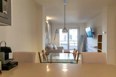 a kitchen and living room with a table and chairs at 
