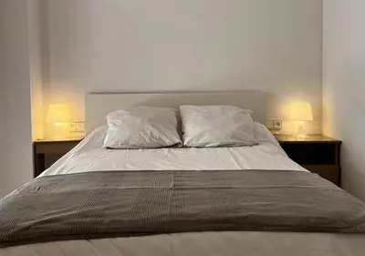 a bed with two pillows on top of it at Espacioso con patio interior in Sabadell