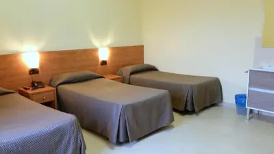 a hotel room with two beds and two lamps at Hostal Capitol Ramblas in Barcelona