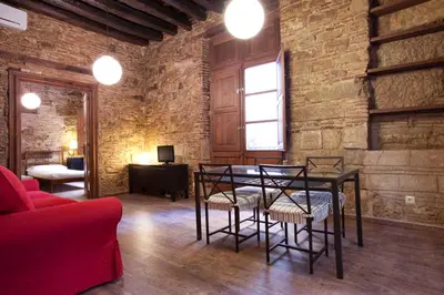 a room with a table and chairs and a brick wall at El Born - Barcelona Center Apartment in Barcelona