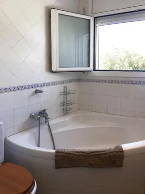 a bath tub in a bathroom with a window at Eco house of oak, 15 min to BCN Max Pax 8 in Sant Cugat del Vallès