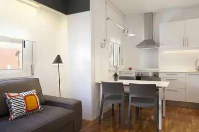 a living room with a couch and a table in a kitchen at Barceloneta near Beach Apartments in Barcelona
