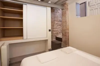 a bedroom with a white bed and a window at Barceloneta Apartment in Barcelona