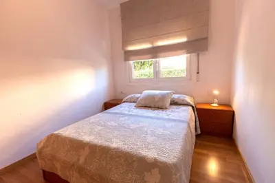 a small bedroom with a bed and a window at Catalunya Casas Cozy beach town villa for 8 - no car necessary! in Pineda de Mar