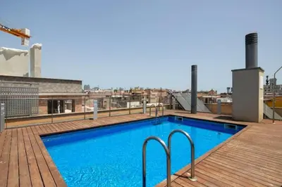 a swimming pool on the roof of a building at Near Ramblas apartment 3 room flat Min 32 days in Barcelona