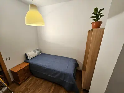 a small room with a bed and a potted plant at Near Ramblas apartment 3 room flat Min 32 days in Barcelona