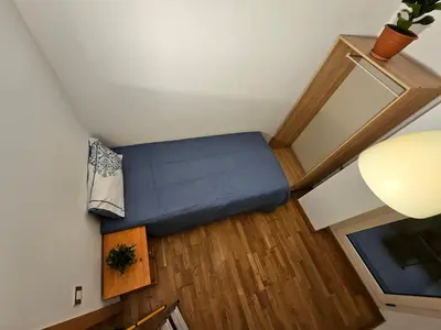 an overhead view of a small room with a blue bed at Near Ramblas apartment 3 room flat Min 32 days in Barcelona