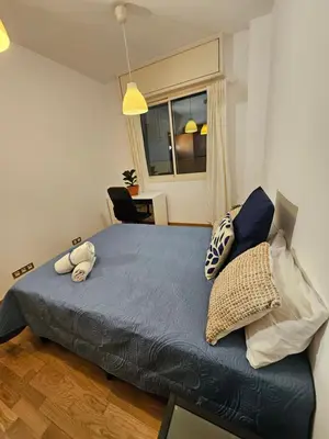 a bedroom with a bed with pillows and a window at Near Ramblas apartment 3 room flat Min 32 days in Barcelona
