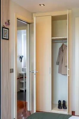 a room with a closet with a shirt and shoes at Canela Homes BARCELONA FÒRUM in Sant Adria de Besos