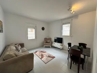 a living room with a couch and a table at Relax Holiday Home in Vallromanas