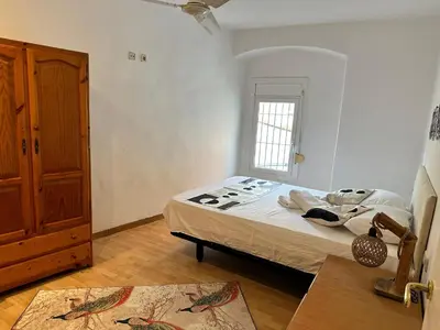 a bedroom with a bed and a window at Relax Holiday Home in Vallromanas