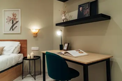 a bedroom with a desk with a book and a bed at Casa Central in Barcelona