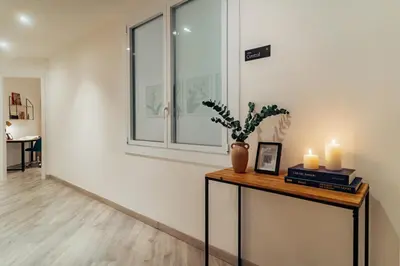 a room with a table with candles and a window at Casa Central in Barcelona