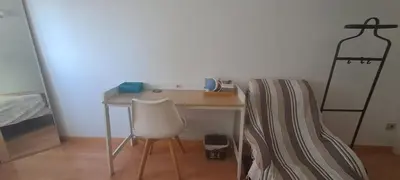 a desk with a chair and a bed in a room at Lovely Room near Park Guell in Barcelona