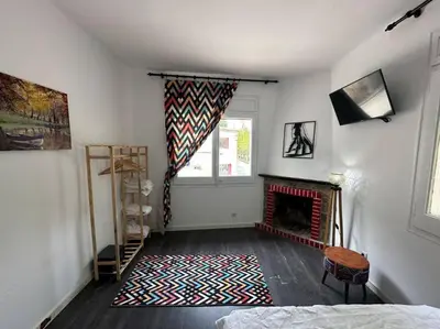 a living room with a fireplace and a window at Casa Vallromanes Rest House in Vallromanas