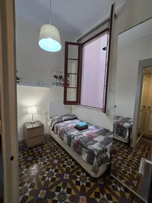 a bedroom with a bed and a window in it at Alojamiento Rogeretto in Barcelona