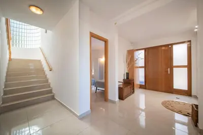 a living room with a staircase and a stair case at Villa Sitges Cambera 10 minutos de Playa andando Muy Comoda Area Tranquila in Sitges