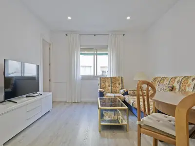 a living room with a couch and a table at Winahost Barcelona Diagonal in Barcelona