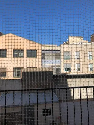 a building reflected in the glass of a building at Charming modern flat in Barcelona in Barcelona