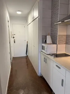 a kitchen with a sink and a microwave at Cozy apartment close to the beach for 2 persons in Gavà