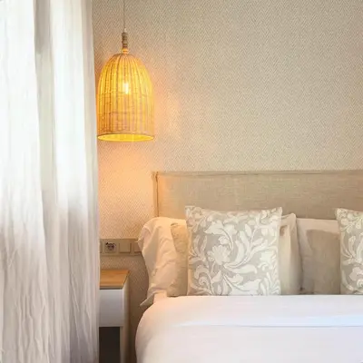 a table with a tray with a drink and a bowl of chips at Montroig 5 hotel boutique in Sitges
