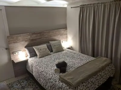 a bedroom with a large bed with a wooden headboard at Acogedor apartamento en la Sagrada Familia in Barcelona
