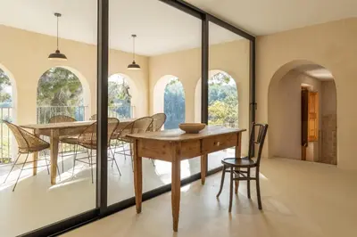 a dining room with a table and chairs at Mas Grimosach - Masía en finca y bodega ecológica - Adults Only in Sant Pau dʼOrdal