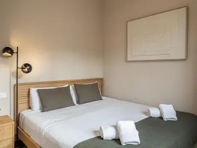 a bedroom with a bed with two towels on it at Sagrada Familia's View 3B1 5Bath in Barcelona