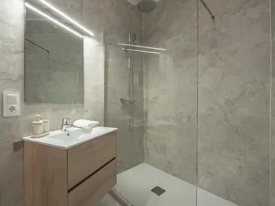 a bathroom with a sink and a glass shower at Sagrada Familia's View 3B1 5Bath in Barcelona