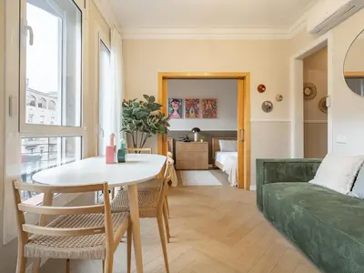 a living room with a table and a couch at Sagrada Familia's View 3B1 5Bath in Barcelona