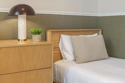 a bedroom with a bed and a lamp and a plant at Sagrada Familia's View 3B1 5Bath in Barcelona