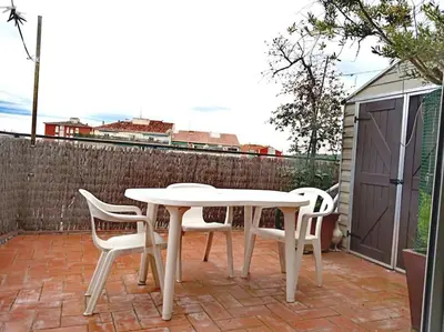 a white table and chairs on a brick patio at Habitación doble exterior en piso compartido in Sant Cugat del Vallès