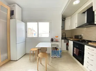 a black cabinet in a room with a wooden floor at Double room with inside window in shared apartment in Barcelona