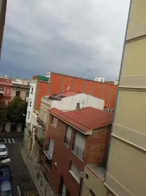 a bathroom with a shower with a tub and a toilet at Double room with inside window in shared apartment in Barcelona