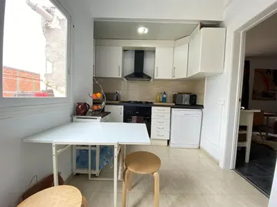 a bathroom with a washing machine and a sink at Double room with inside window in shared apartment in Barcelona