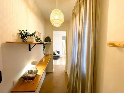 a hallway with a wooden table in a room at Boutique Casanova in Barcelona